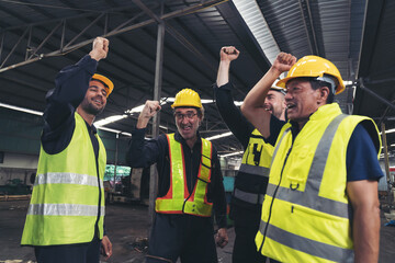 Group of male factory workers standing and show their hands after finished work in industry factory, wearing safety uniform and helmet. Factory workers working completed finish job. Successful of work