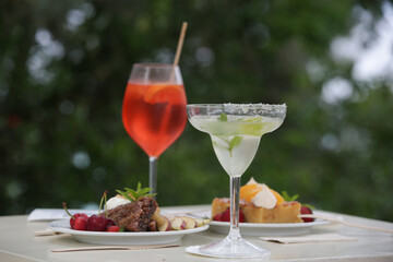 Cocktails and desserts on the table in the outdoor cafe