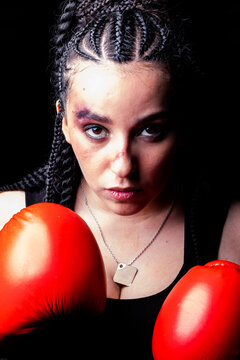 Close-up portrait of a female boxer with her fists raised ready to fight