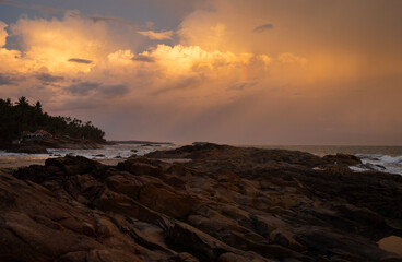 Obraz premium sunset over the sea, beautiful seascape during sunset featuring a vivid orange and yellow sky with golden sunlight , peaceful coastal scenery perfect for travel, nature, and relaxation themes.