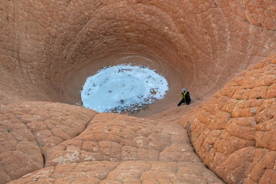 Woman sitting in The Vortex (The Bowl) near St George, Dammeron Valley, Red Mountain Wilderness, Utah, USA