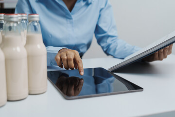 Expert control quality milk factory worker checking milk bottle quality control procedure, Dairy...