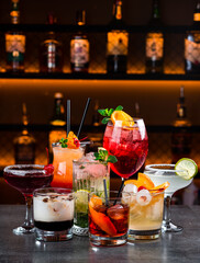 Set of classic alcoholic cocktails, fresh cold drinks on the bar counter.