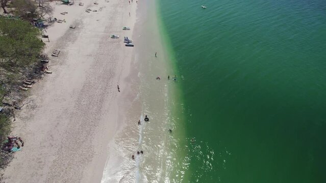 Scenic Flyover Busy Conchal Beach Costa Rica On Sunny Summer Day, 4K Aerial Drone