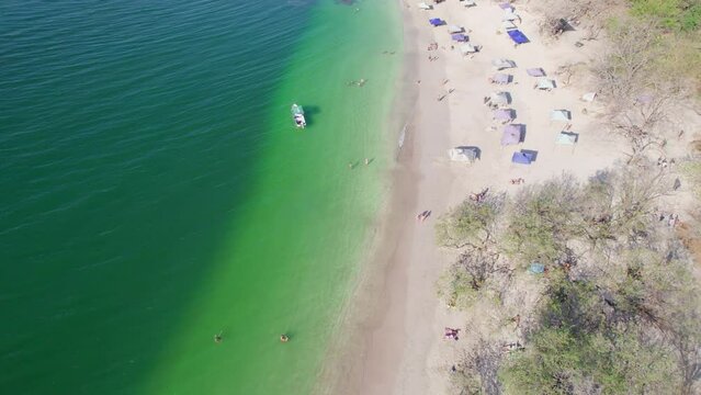 Aerial Drone 4K View Over People On Conchal Beach And Boat In Blue Ocean, Costa Rica