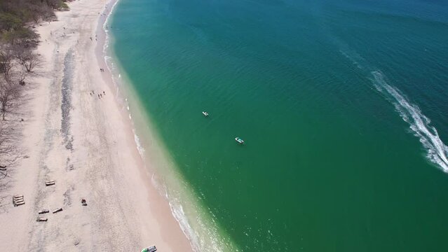 Aerial Drone Flyover Conchal Beach Costa Rica With Boat On Blue Ocean, 4K 