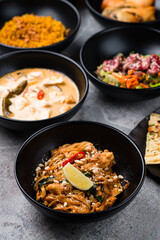 Rice noodle pad thai with chicken, corn soup with chicken broth and pork, meat salad with beef and rice with fried onions.