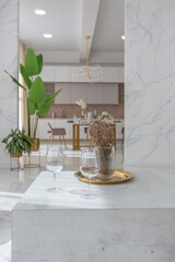 light luxury interior design of a modern apartment in a minimalist style with marble trim and huge windows. daylight inside the kitchen and living room