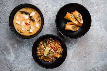 Corn soup with pork, Thai pancakes stuffed with meat, seafood and rice noodle pad thai with chicken.