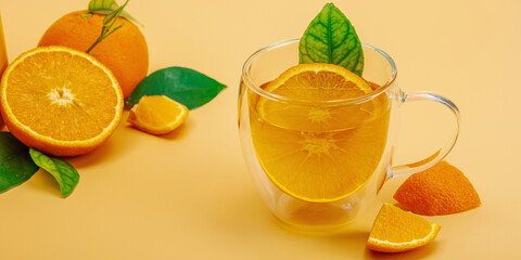 Orange tea in ceramic tea pot with ripe fruits. Refreshment seasonal drink, conceptual background