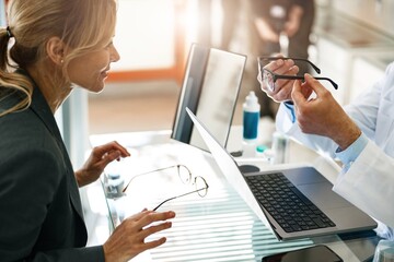 Ophthalmologist offers the client to replace the old spectacle frame with a modern one