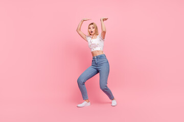 Fototapeta na wymiar Full body length photo of young excited girl hold hard big weight empty space product pressure isolated on pastel pink color background