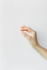 female hand holding something with fingers on white background
