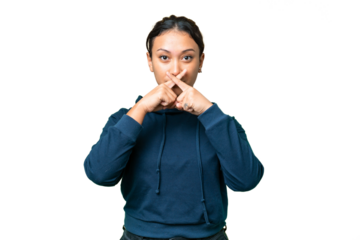 Young Uruguayan woman over isolated chroma key background showing a sign of silence gesture