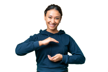 Young Uruguayan woman over isolated chroma key background holding copyspace imaginary on the palm to insert an ad