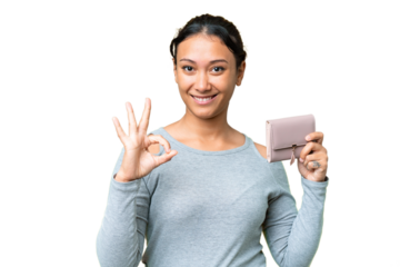 Young Uruguayan woman holding a wallet over isolated chroma key background showing ok sign with fingers