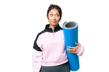 Young sport woman going to yoga classes while holding a mat over isolated chroma key background and looking up
