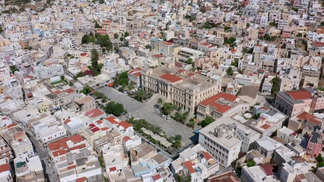 Aerial: Slow panning drone shot of Miaoulis square in Ermoupoli of Syros island, Greece on a sunny day