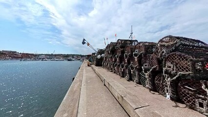 crab pots, lobster pots and fish traps on the historic grade 2 listed Tate Hill Pier in Whitby harbour on the North Yorkshire Coast. Captured on a bright and sunny summer day