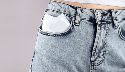Condoms in jeans pocket. Prevent infection. The concept of sexual health.