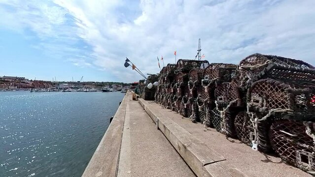 crab pots, lobster pots and fish traps on the historic grade 2 listed Tate Hill Pier in Whitby harbour on the North Yorkshire Coast. Captured on a bright and sunny summer day