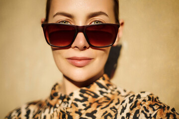  Classic eye wear fashion. Beautiful youg woman wear shirt with a leopard print and classy square...