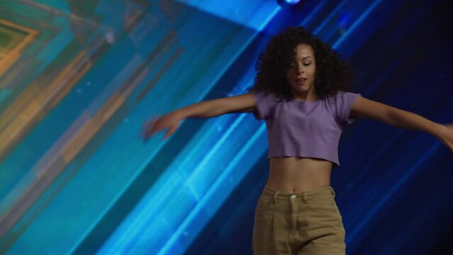 Young female woman girl dancer is performing her dance during talent show auditions. Recording of television style broadcast talent show