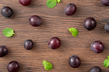 Delicious bunch of grapes fruit spilled over wooden table background.
