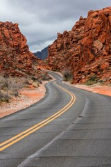 Desert Serenity: Panoramic View of an Empty Road Surrounded by Red Rock Canyon After a Storm, Presented in Captivating 4K Resolution