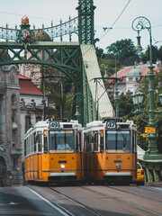 Two trolley cars going in different directions in the city of Budapest