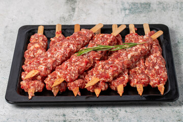 Adana kebab. Turkish raw adana kebab on gray background. Turkish cuisine delicacies