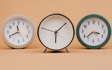 Alarm clock. Beautiful modern clock lies on paper background. time clock time standstill time off...