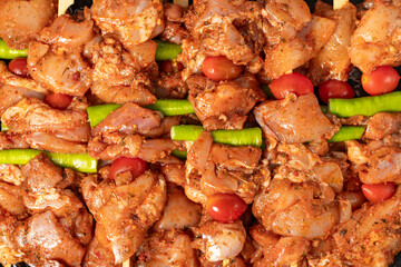 Chicken skewer. Close-up chicken skewers with raw sauce. Food background