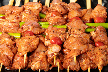 Chicken skewer. Close-up chicken skewers with raw sauce. Food background