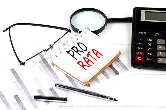 PRO RATA text on notebook with calculator on diagram background