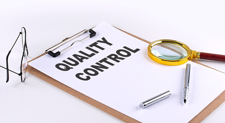 QUALITY CONTROL text on clipboard on white background, business concept