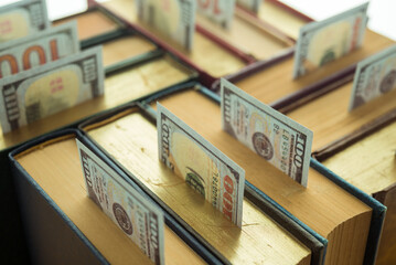 US dollar bill banknotes growing up from many textbook. Concept of rich, wealth and gain success...