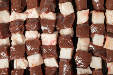 Liver skewer. Close-up raw liver shish kebab. Food background.Turkish cuisine delicacies. Local name ciger sis