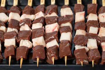 Liver skewer. Close-up raw liver shish kebab. Food background.Turkish cuisine delicacies. Local name ciger sis