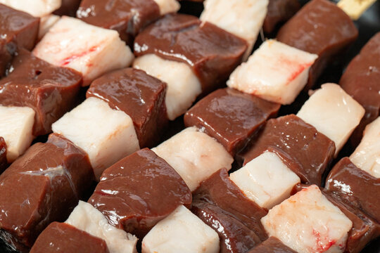Liver skewer. Close-up raw liver shish kebab. Food background.Turkish cuisine delicacies. Local name ciger sis