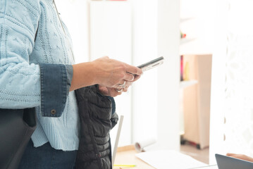 Adult woman with a cell phone in her hand