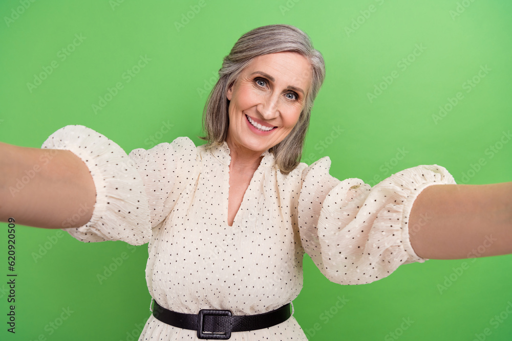 Sticker Photo portrait of beautiful grandma make selfie influencer streaming wear trendy white outfit isolated on green color background