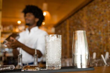 glass with bartender behind it