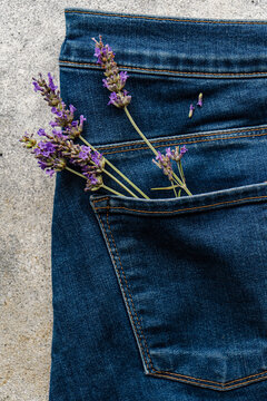 Lavender flowers in the back pocket of a pair of blue jeans