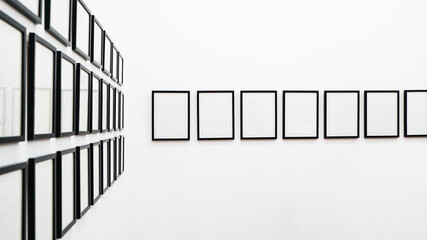 Roll of picture frames hanging on white wall
