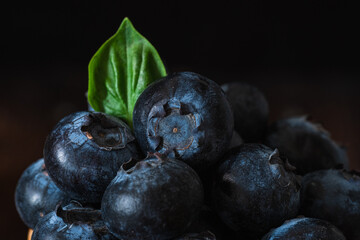 blueberries on a green leaf