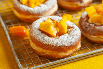 Brioche doughnut mango flavour freshly baked and sugar coated with custard filling.