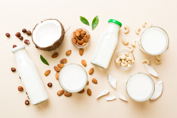 Obraz na płótnie Canvas Set or collection of various vegan milk almond, coconut, cashew, on table background. Vegan plant based milk and ingredients, top view