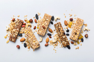 Various granola bars on table background. Cereal granola bars. Superfood breakfast bars with oats, nuts and berries, close up. Superfood concept