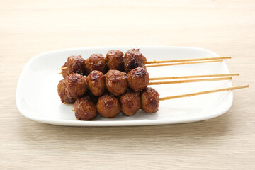 Grilled meatballs skewers with teriyaki sauce

